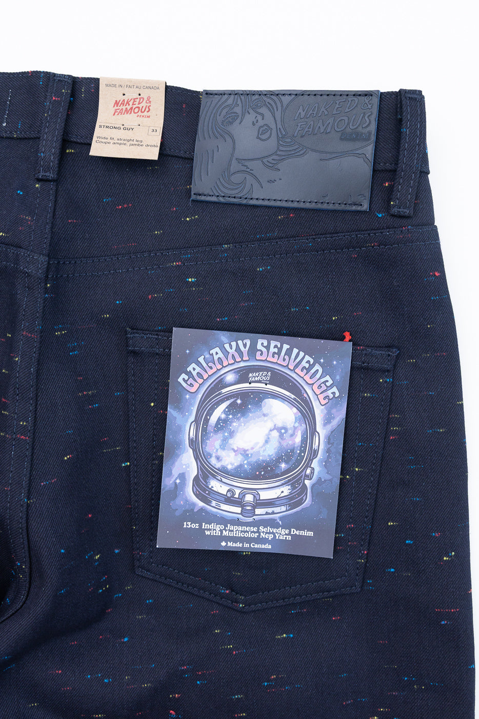 Back view close-up of dark indigo selvedge denim jeans with multicolored nep yarn texture.