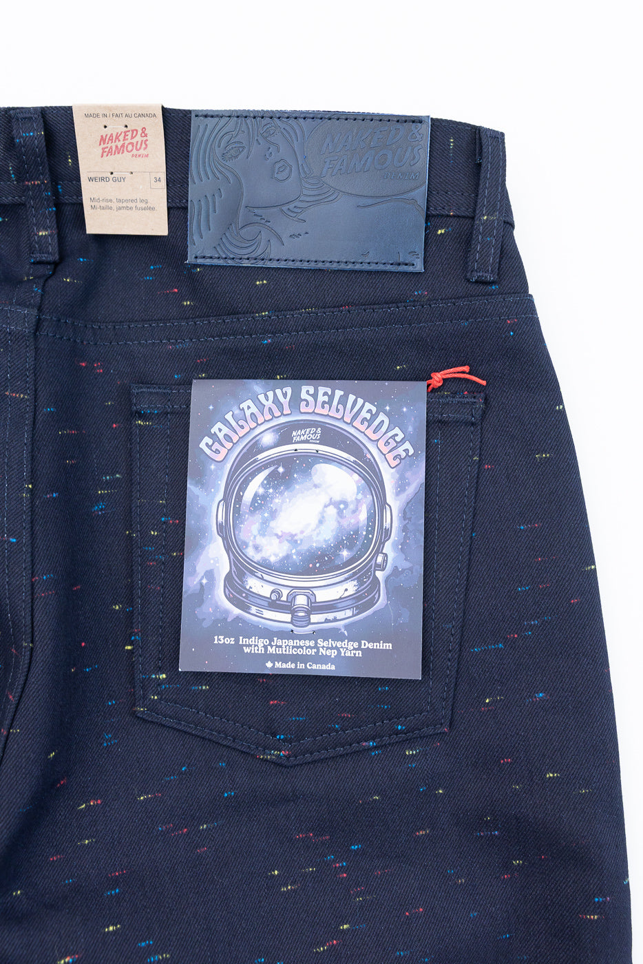 Back view close-up of dark indigo Galaxy Selvedge denim jeans with multicolor nep yarn detail.