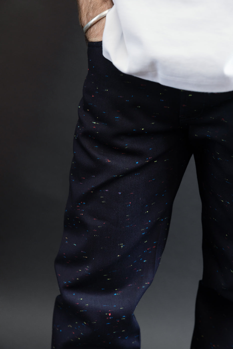 Close-up of the front of male model's navy patterned trousers showing fabric texture.