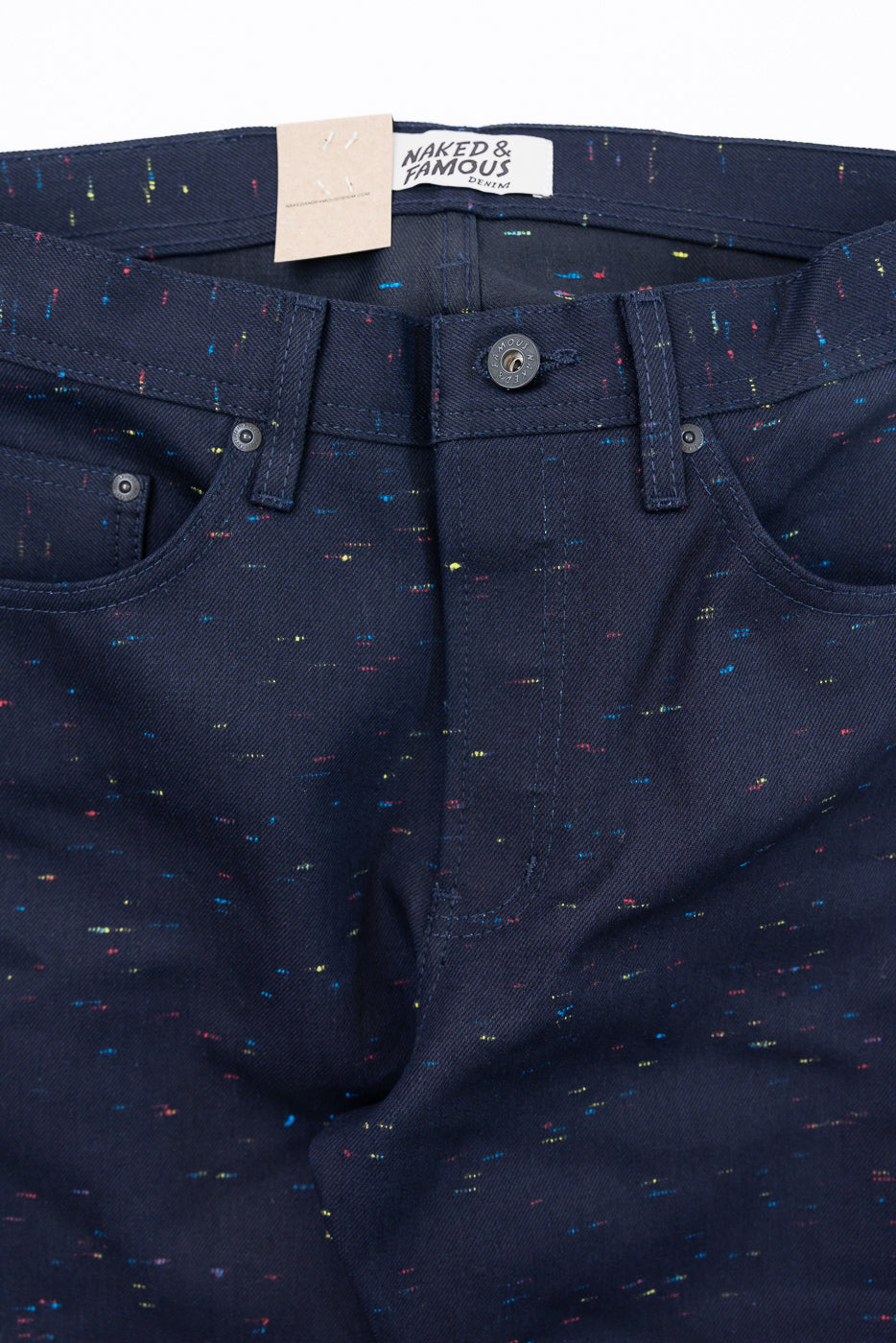 Close-up front view of dark indigo denim jeans showing fabric texture and button detail.