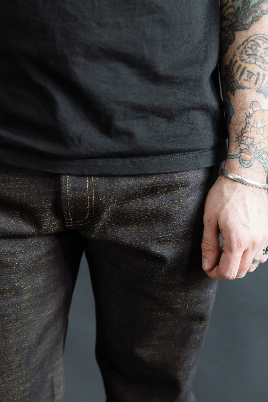 Close-up front view of men's selvedge jeans waist and thigh on 5'9