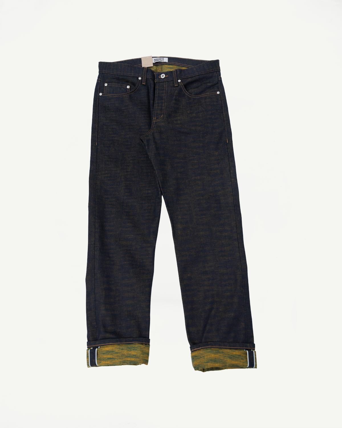 Flat lay of selvedge denim jeans, front view, showing unique yellow cuff and button fly.