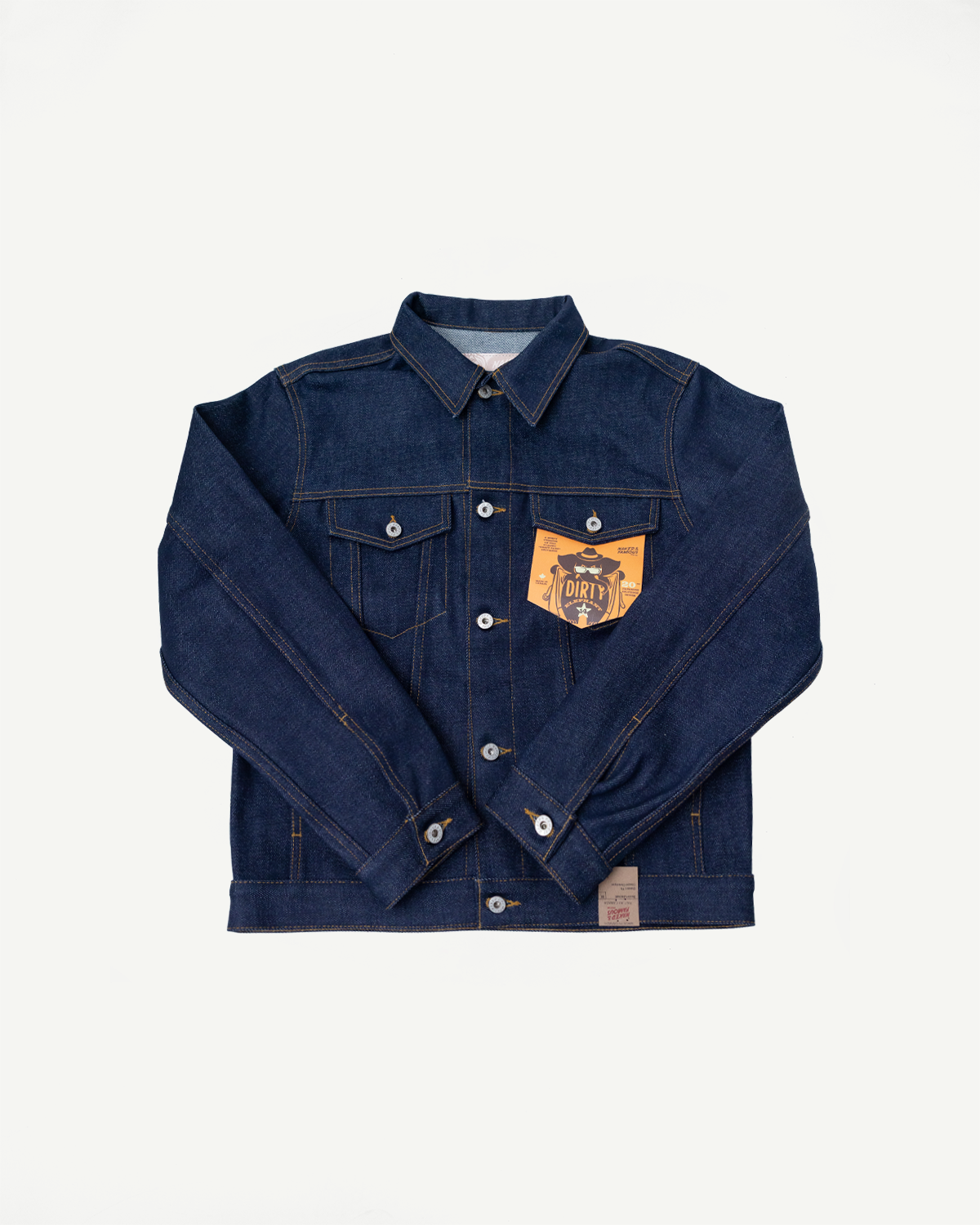 Flat lay front view of Naked & Famous 20oz Dirty Elephant selvedge denim jacket, close-up on buttons, collar, and chest pocket tag, Dant contemporary casual apparel.