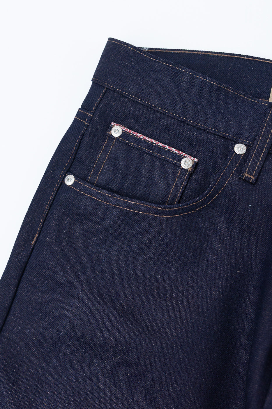 Close-up of front right pocket and coin pocket with selvedge detail on dark denim jeans