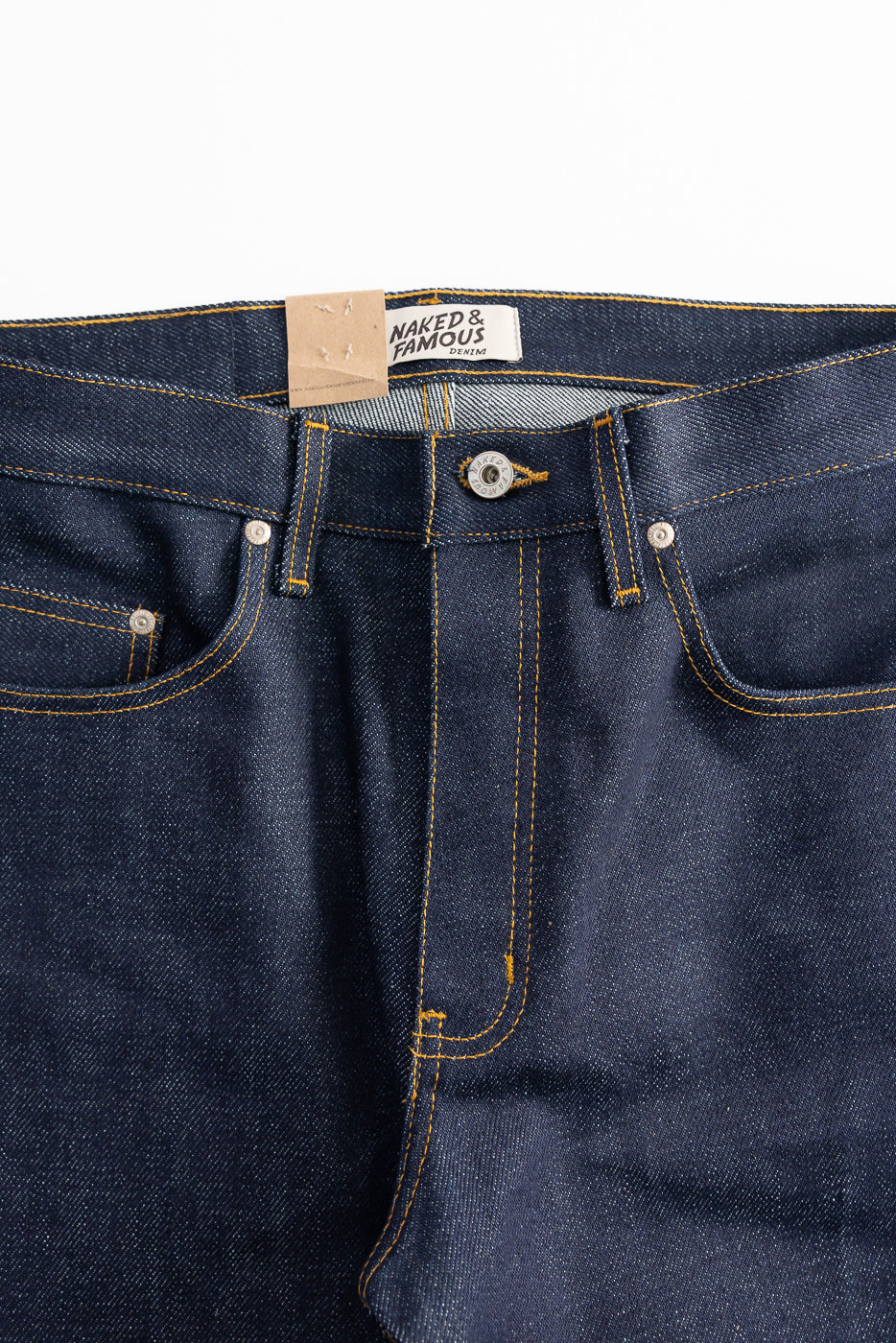 Close-up front view of Naked & Famous Dirty Elephant 14oz selvedge denim jeans waistband, button, and pockets.