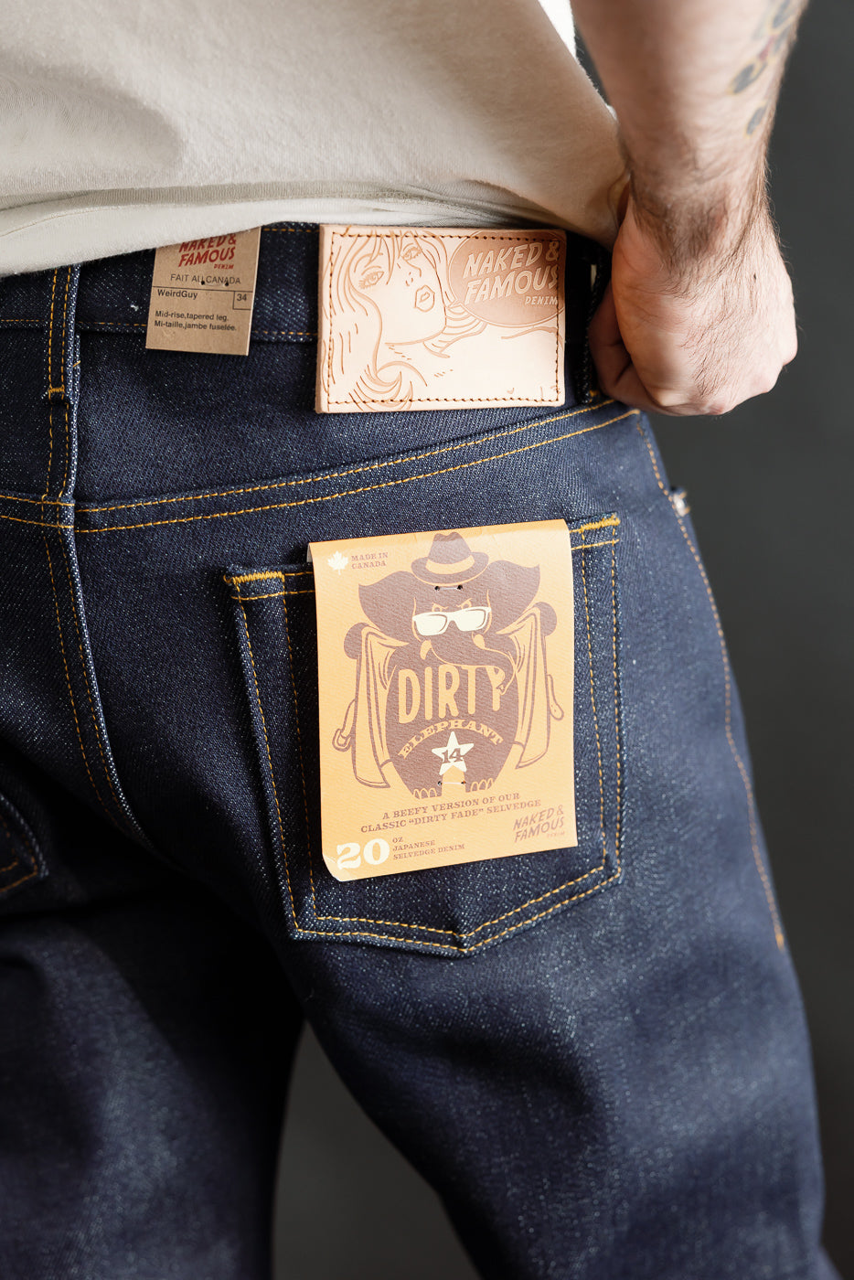 Close-up of rear of Naked & Famous Dirty Elephant 14oz selvedge jeans on male model, 5'9