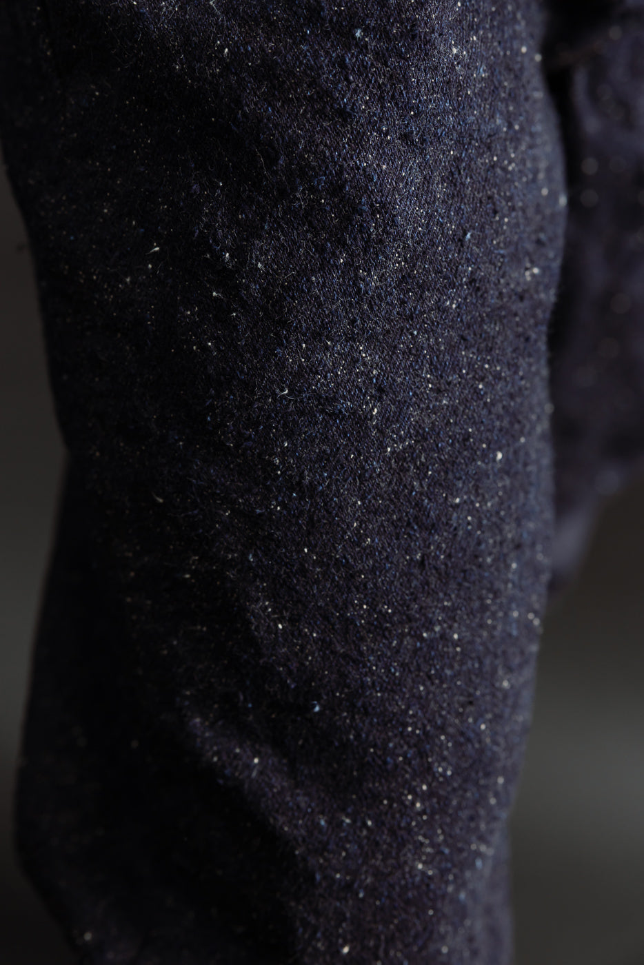 Close-up of Naked & Famous Genseki Selvedge denim fabric texture, side leg detail.