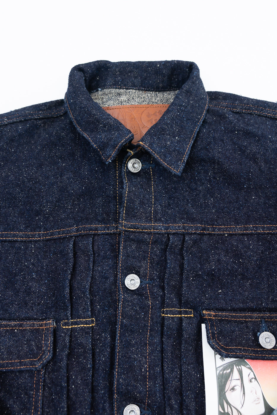 Close-up front view of selvedge heritage denim jacket showing collar, buttons, and chest pocket detail