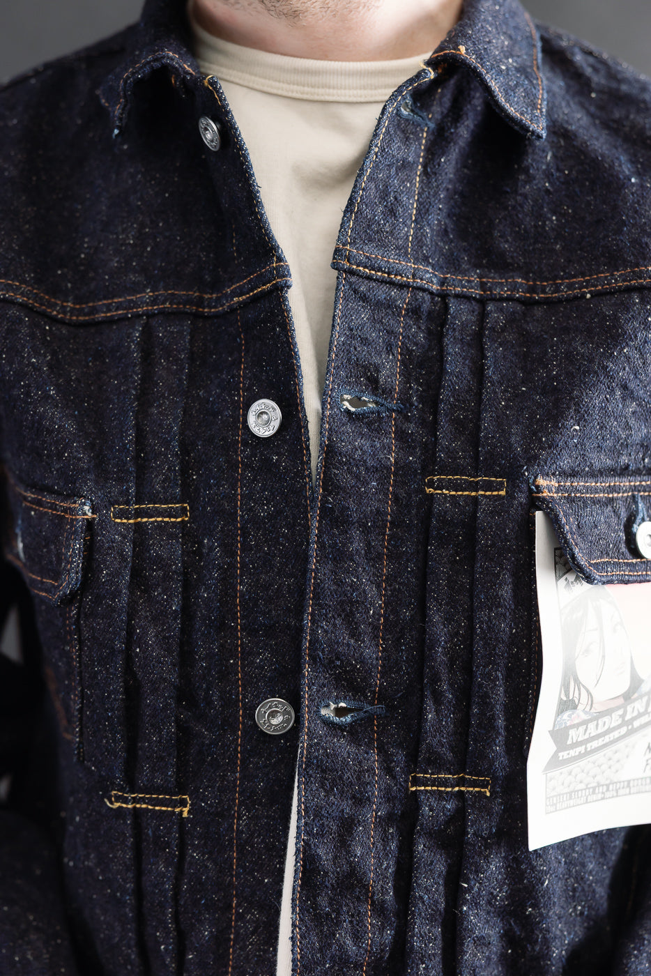 Close-up front of Naked & Famous Genseki selvedge denim jacket on male model, athletic build, 5'9