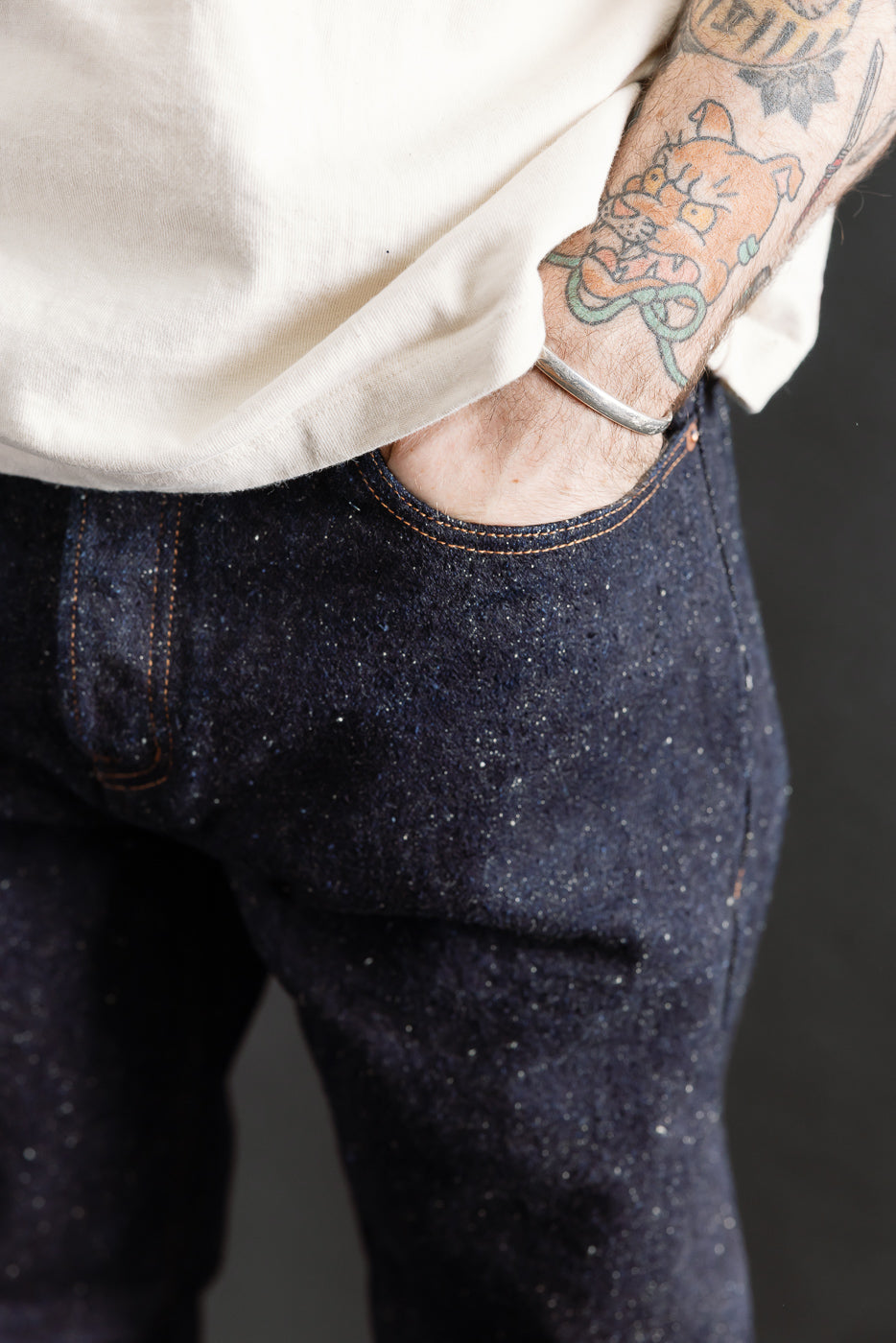 Close-up front detail of selvedge denim jeans texture, male model 5'9