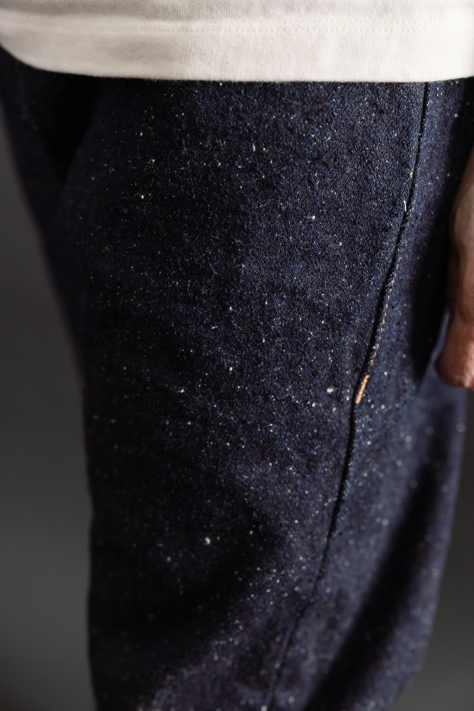 Close-up of male model's right thigh in Naked & Famous Genseki selvedge jeans, navy textured fabric