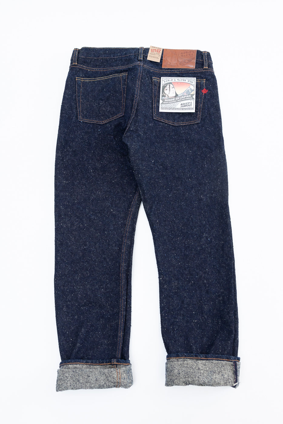 Flat lay of Naked & Famous MIJ16 Genseki Selvedge jeans back view, shows rear pockets, tags, and selvedge cuff details