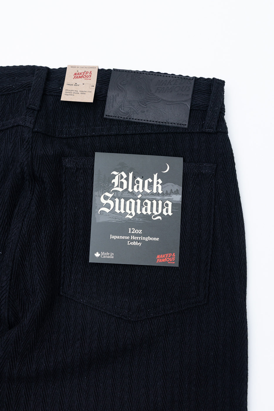 Back view flat lay close-up of black 12oz Japanese herringbone lobby denim texture.