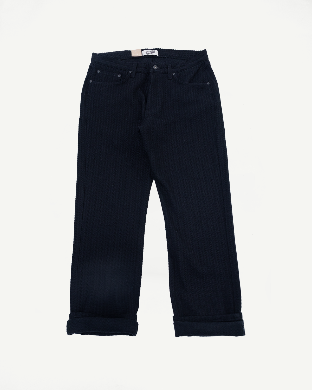 Front view flat lay of navy blue corduroy pants with cuffed hems and a waist tag.