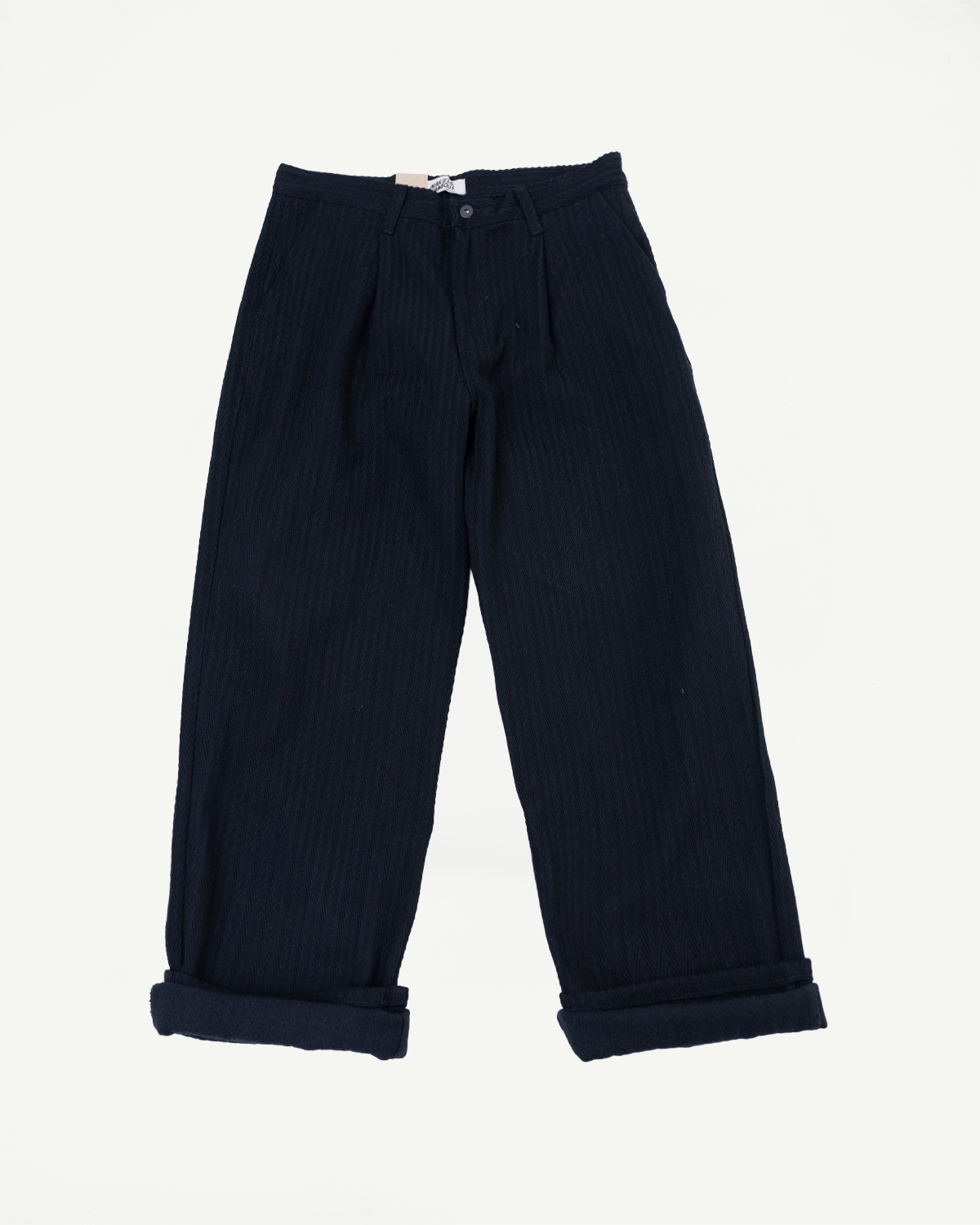 Front view flat lay of navy blue wide-leg corduroy trousers with cuffed hems.