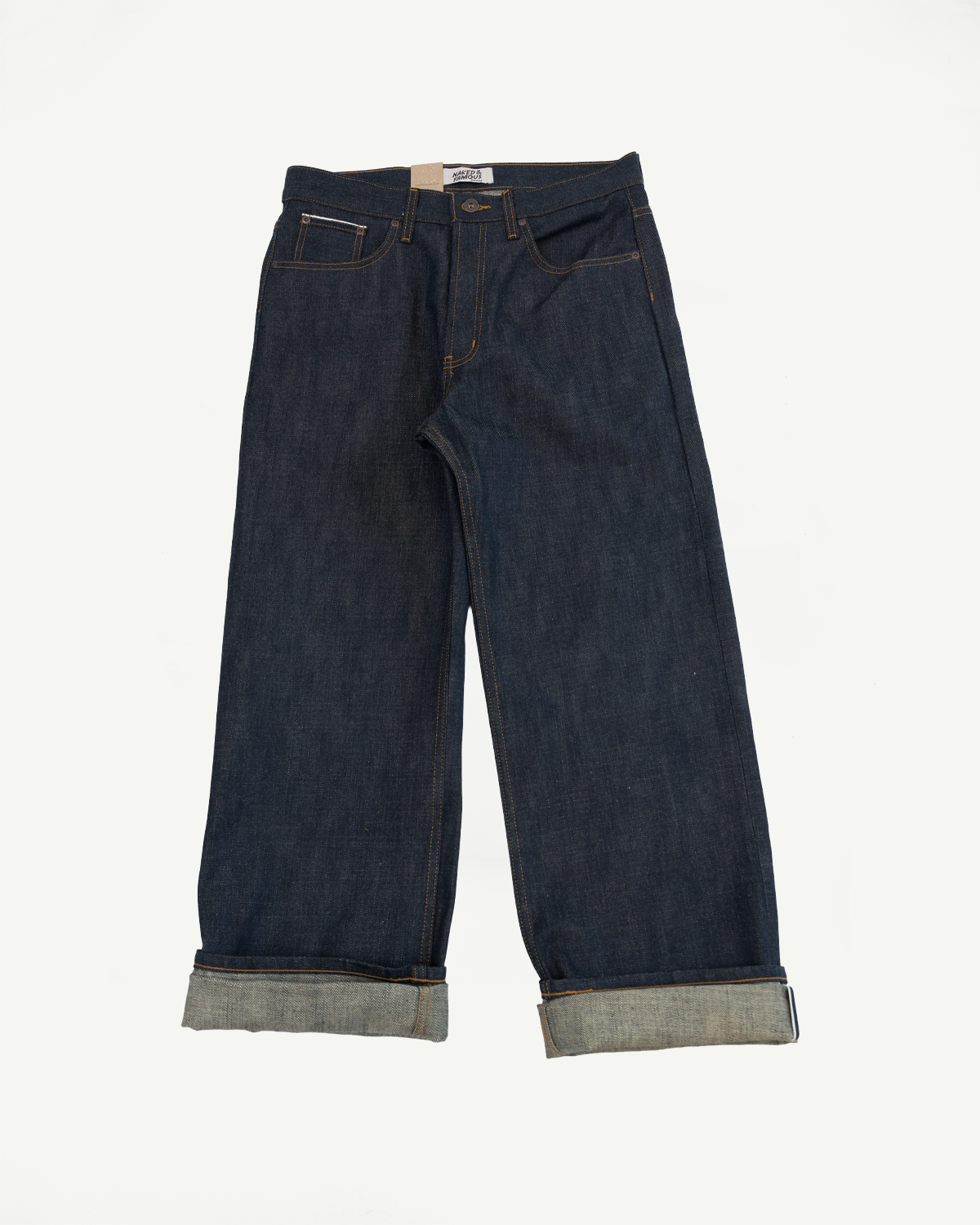Front view of selvedge denim jeans with cuffed hems, showcasing texture and stitching details.