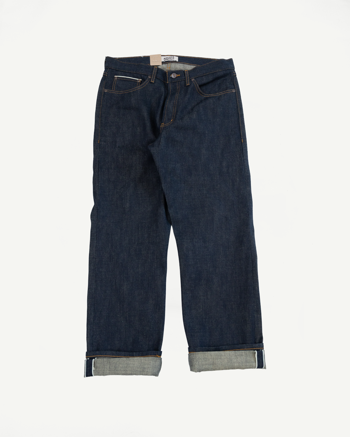 Front view of selvedge denim jeans with cuffed hems, showcasing texture and stitching details.