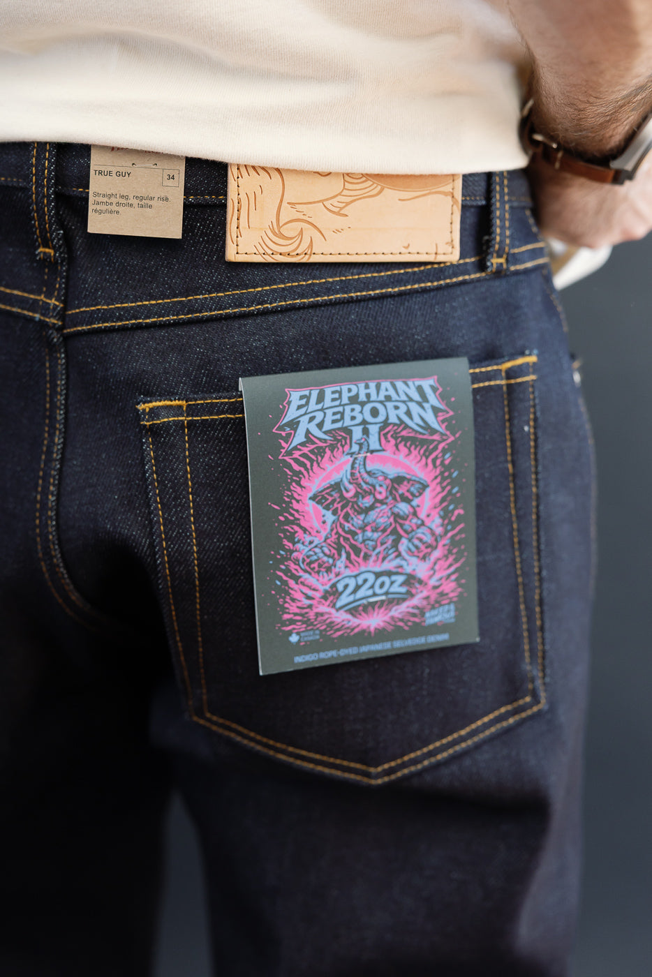 Close-up back view of a male model wearing Elephant Reborn H 22oz indigo rope-dyed Japanese selvedge denim jeans.