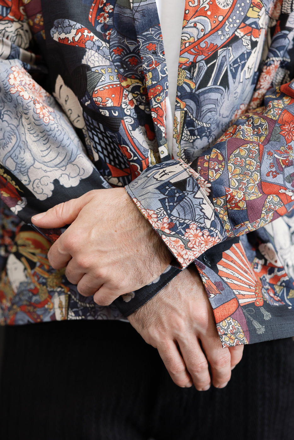 Close-up of the sleeve cuff and patterned fabric detail on a multicolored Japanese-style blazer.