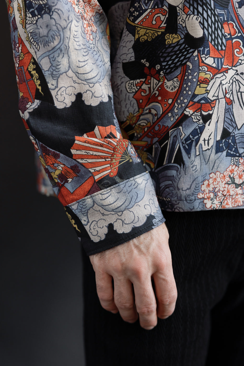 Close-up of the sleeve and patterned fabric on a male model, 5'9
