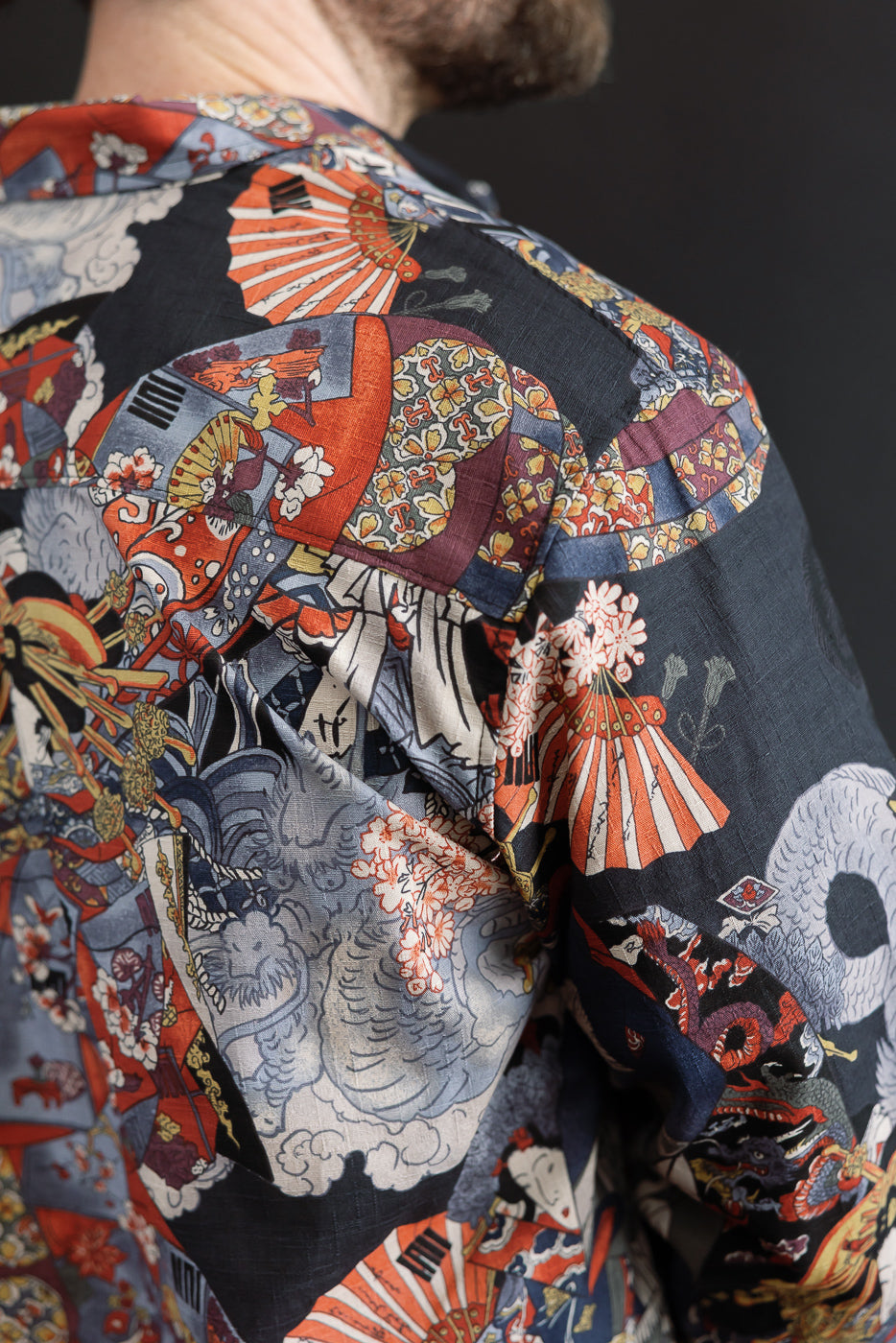 Close-up back view of a patterned short sleeve shirt showing intricate fabric texture and print.