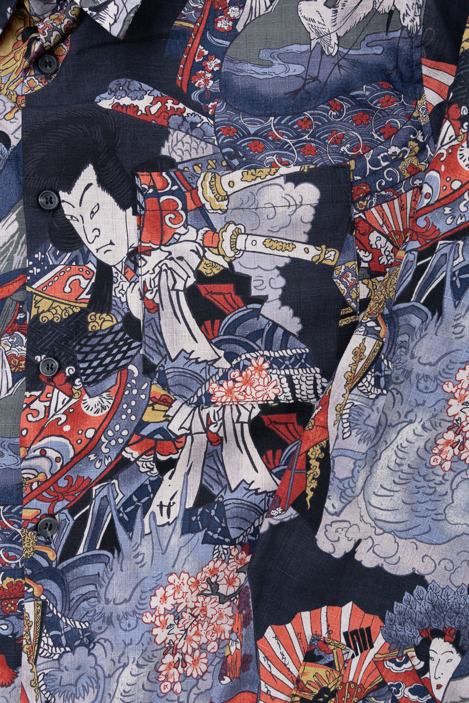 Close-up of the front fabric texture and Japanese ukiyo-e print detail on a navy button-up shirt.