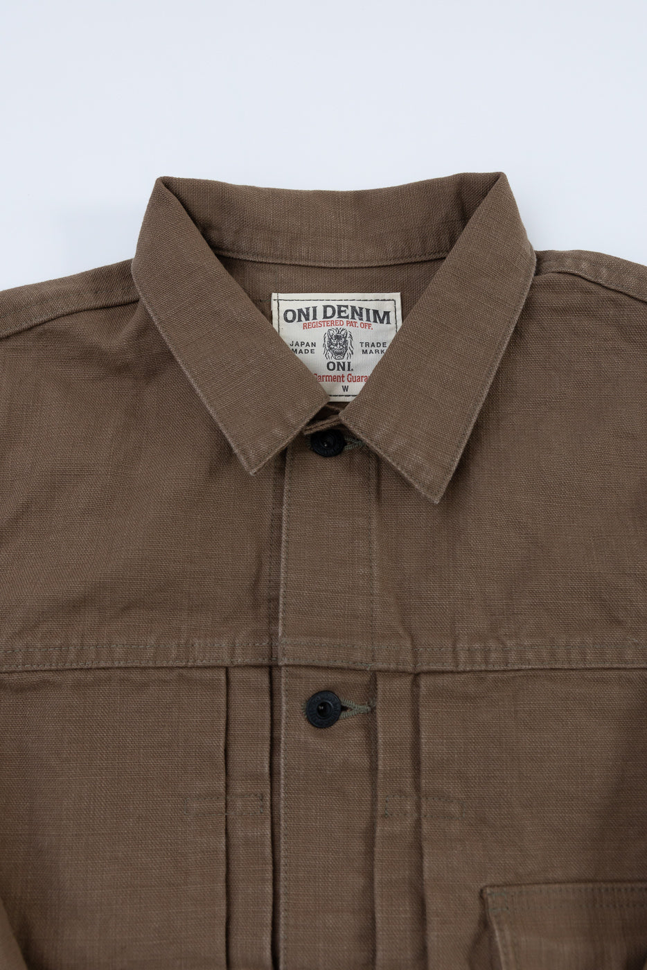 01507-HOX-BRK - 13oz Brown Khaki Sulfur Dyed Heavy Oxford Jacket - Type I, showcasing a chore jacket style with pointed collar, button-up front, and ONI DENIM label against a light background.