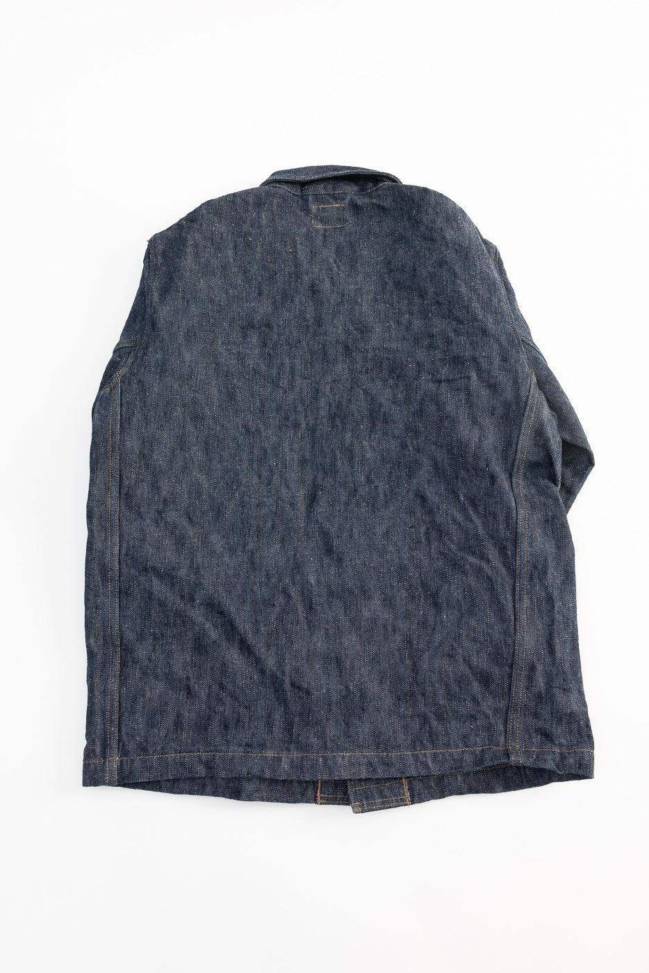 Flat lay of ONI denim selvedge jacket, back view showing straight hem and collar details
