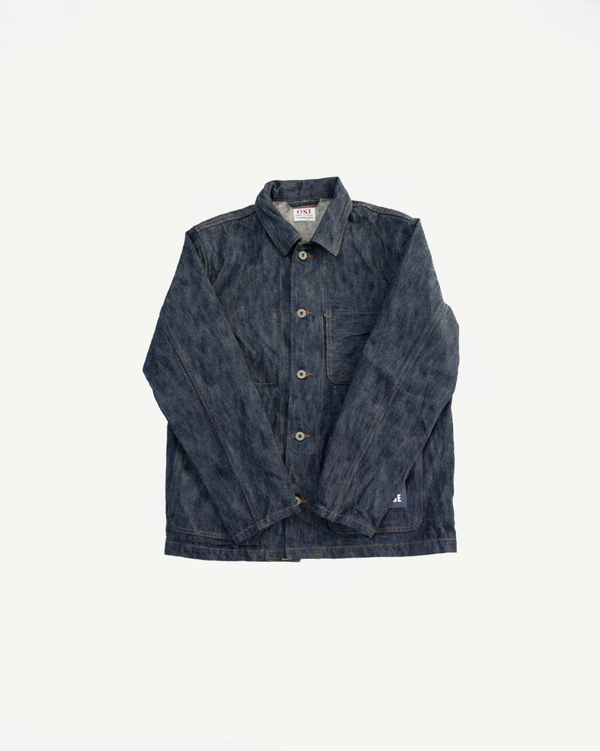 Flat lay of ONI 16oz selvedge denim jacket, front view showing buttons, collar, and pockets.