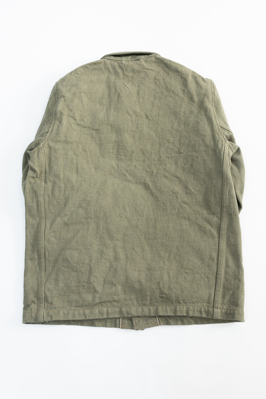 Flat lay of olive denim selvedge jacket, back view, showing rear panel and seam details