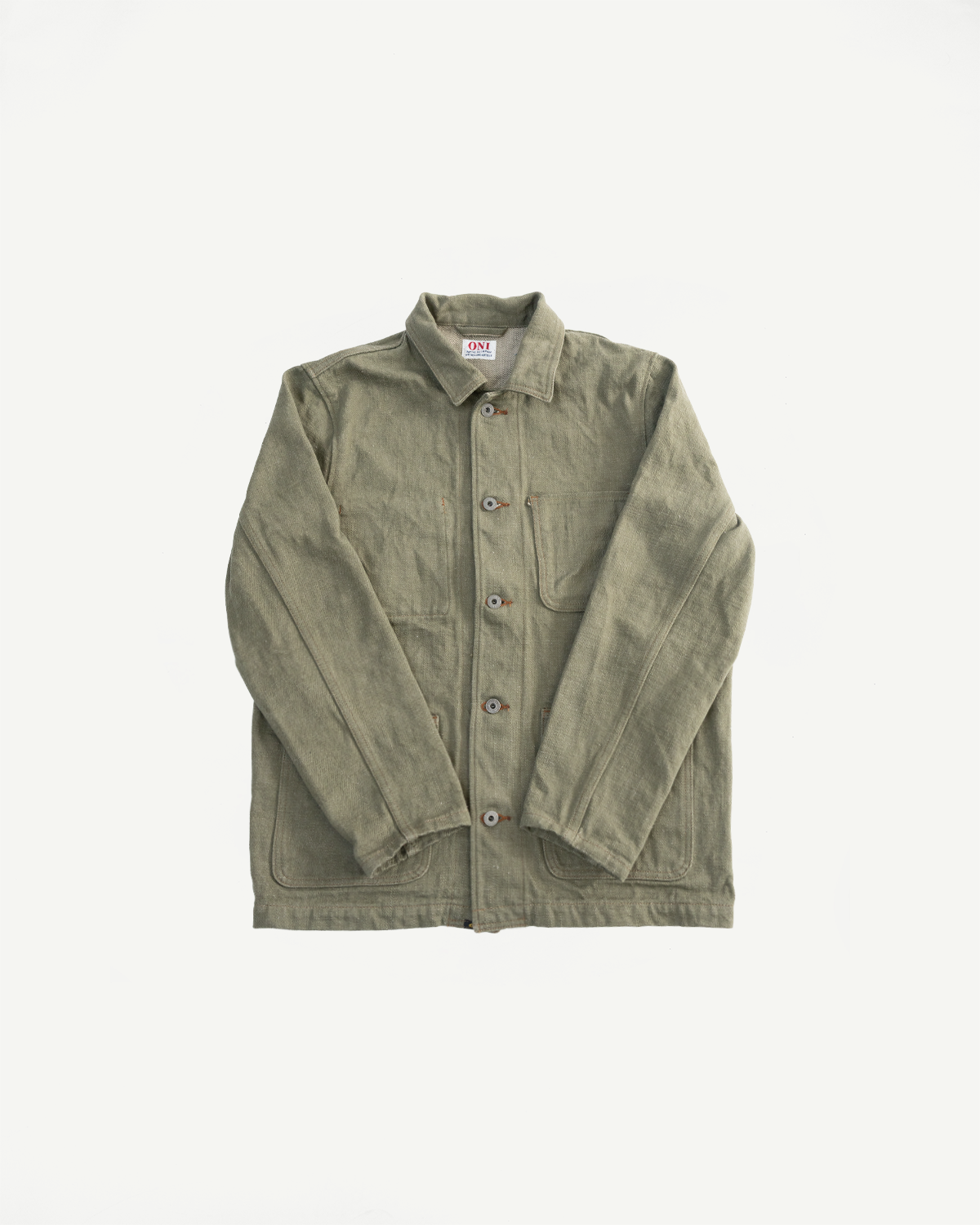 Flat lay of olive selvedge denim coverall jacket, front view, showing collar, buttons, and pockets.