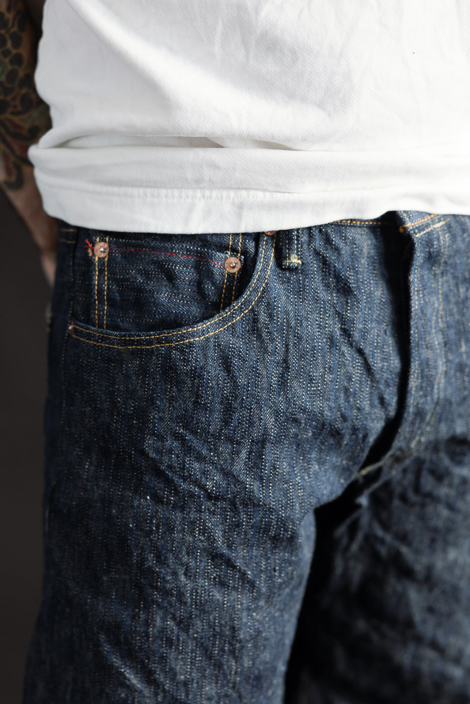 Close-up of front left side of ONI Kase Denim selvedge jeans on male model, 5'9