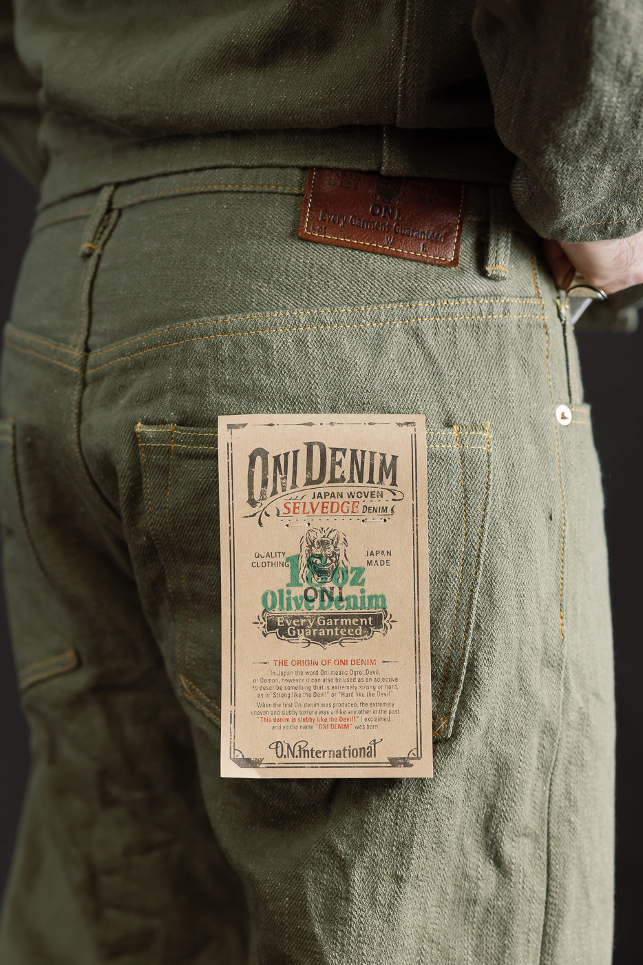 Close-up of back side of olive selvedge jeans on male model 5'9