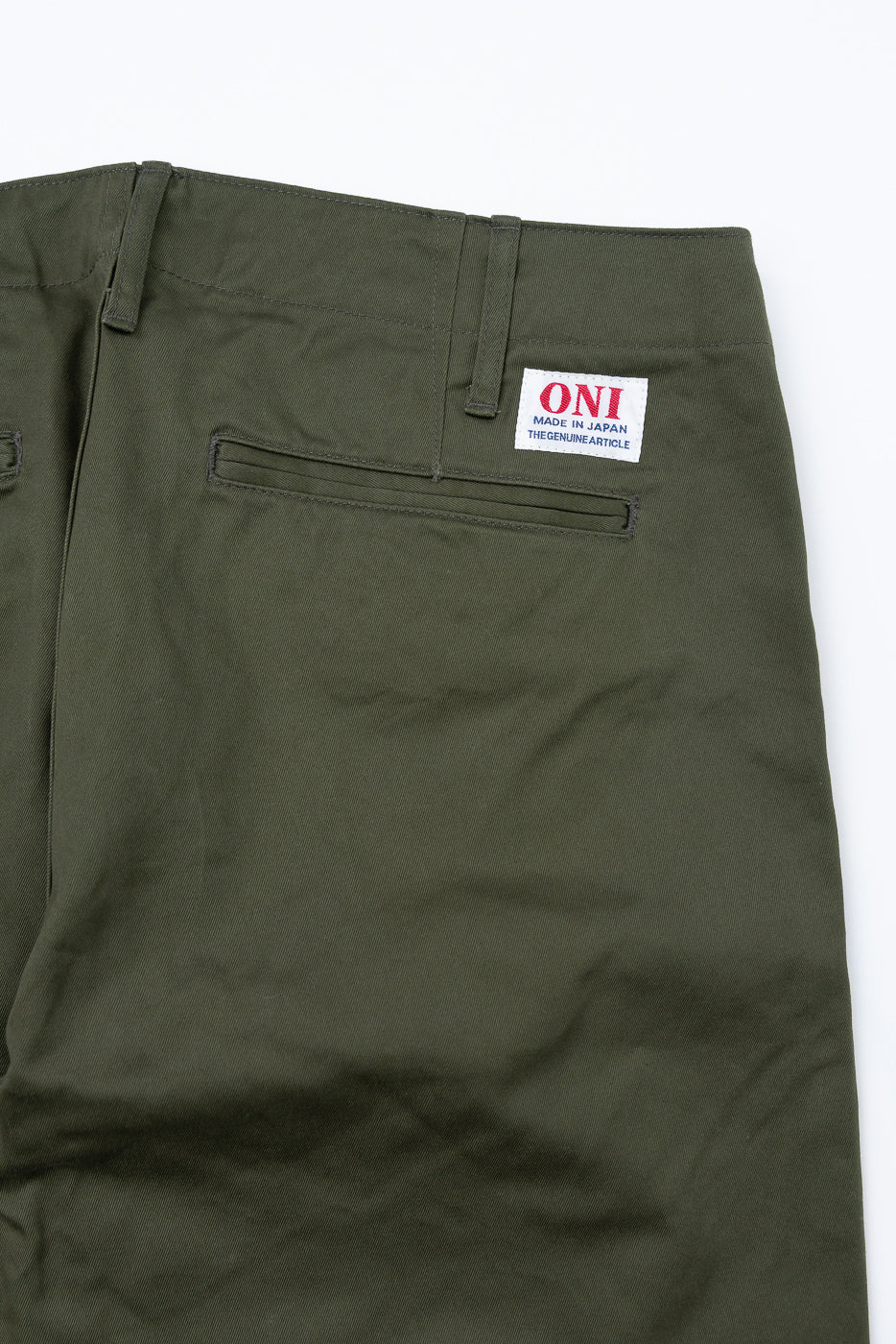 Olive green pants back view, close-up showing ONI tag, pocket, and waistband details
