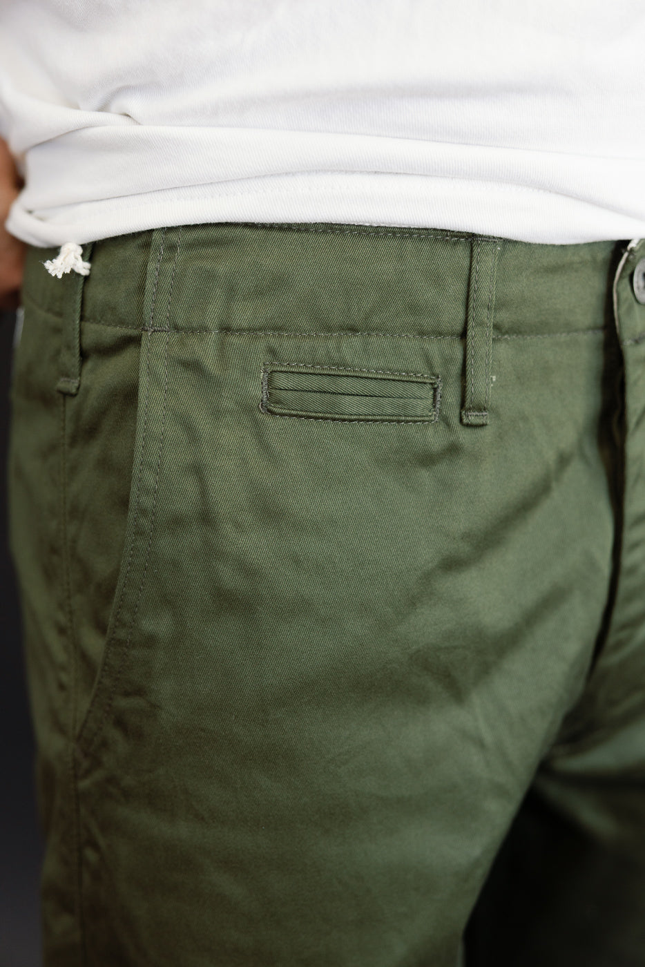 Close-up back view of olive green chino pants on male model, 5'9
