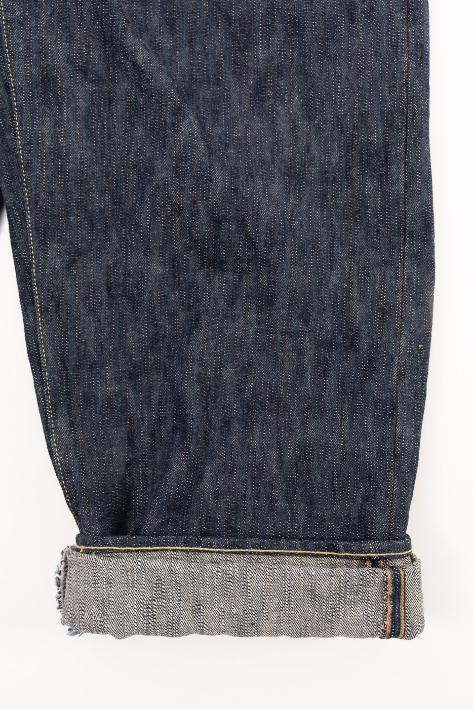 Close-up of the front lower leg and cuff on ONI Kase Denim selvedge jeans showing fabric texture and selvedge detail.
