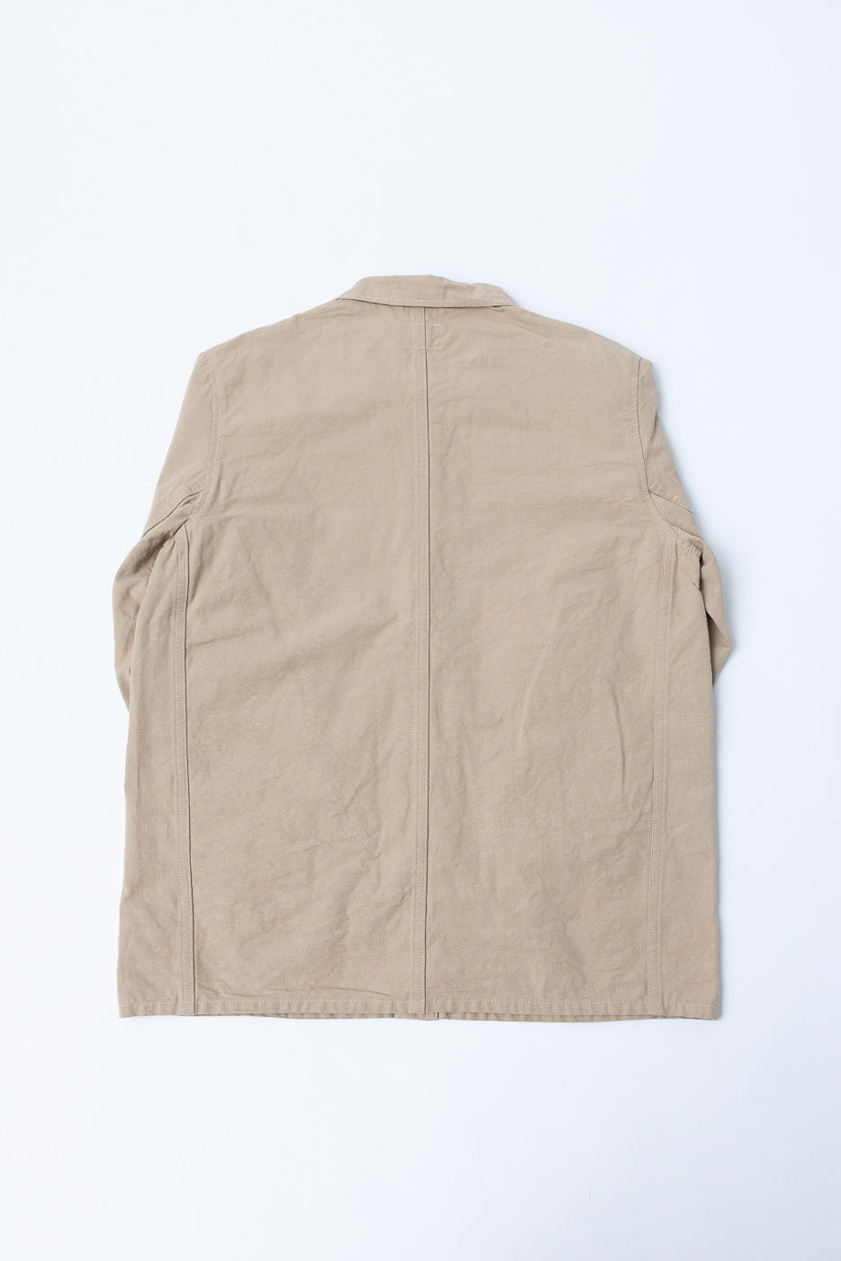 Flat lay back view of beige men's casual shirt, showing back seam, collar, and sleeve details