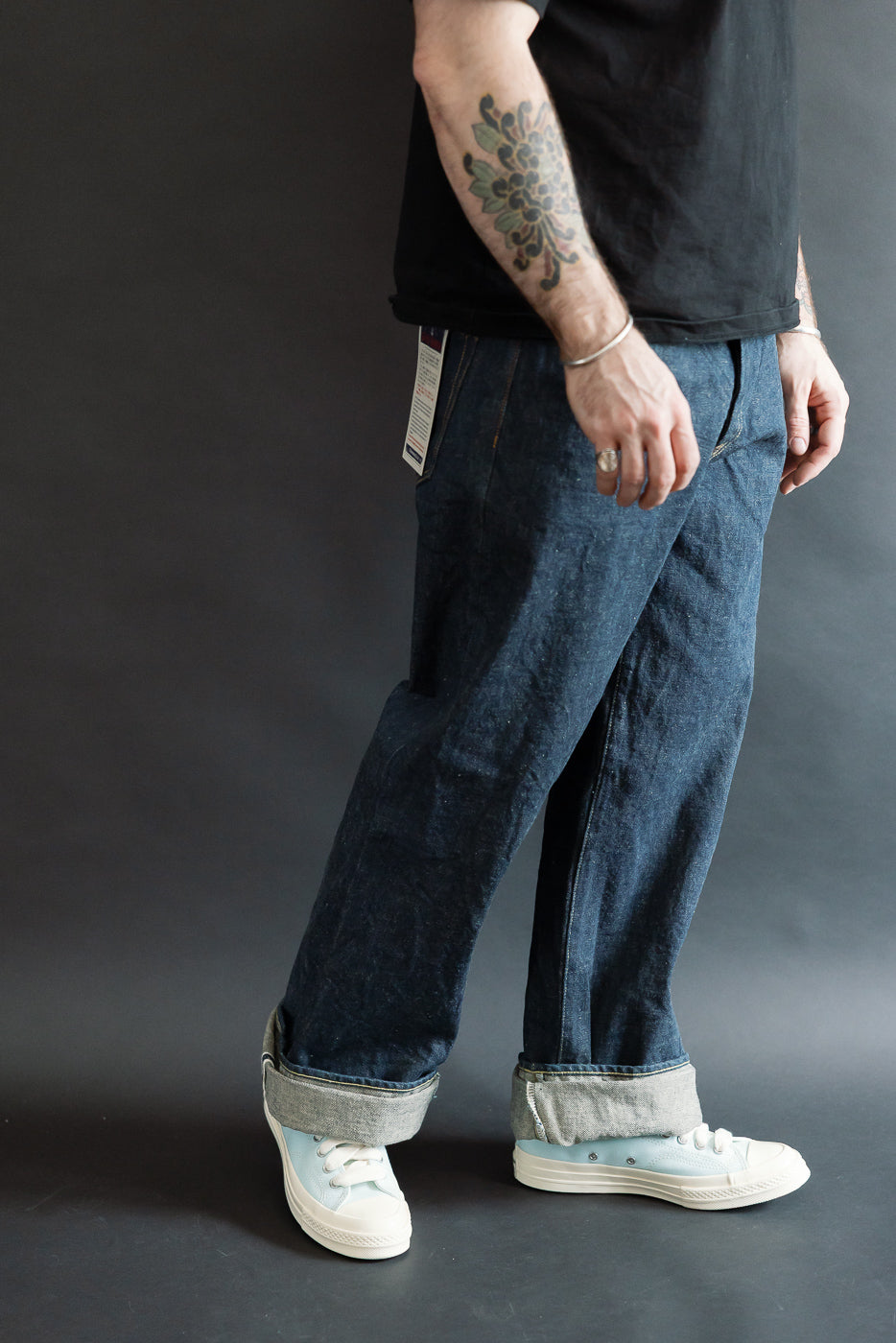 Men’s side view, cuffed selvedge denim jeans, 5'9