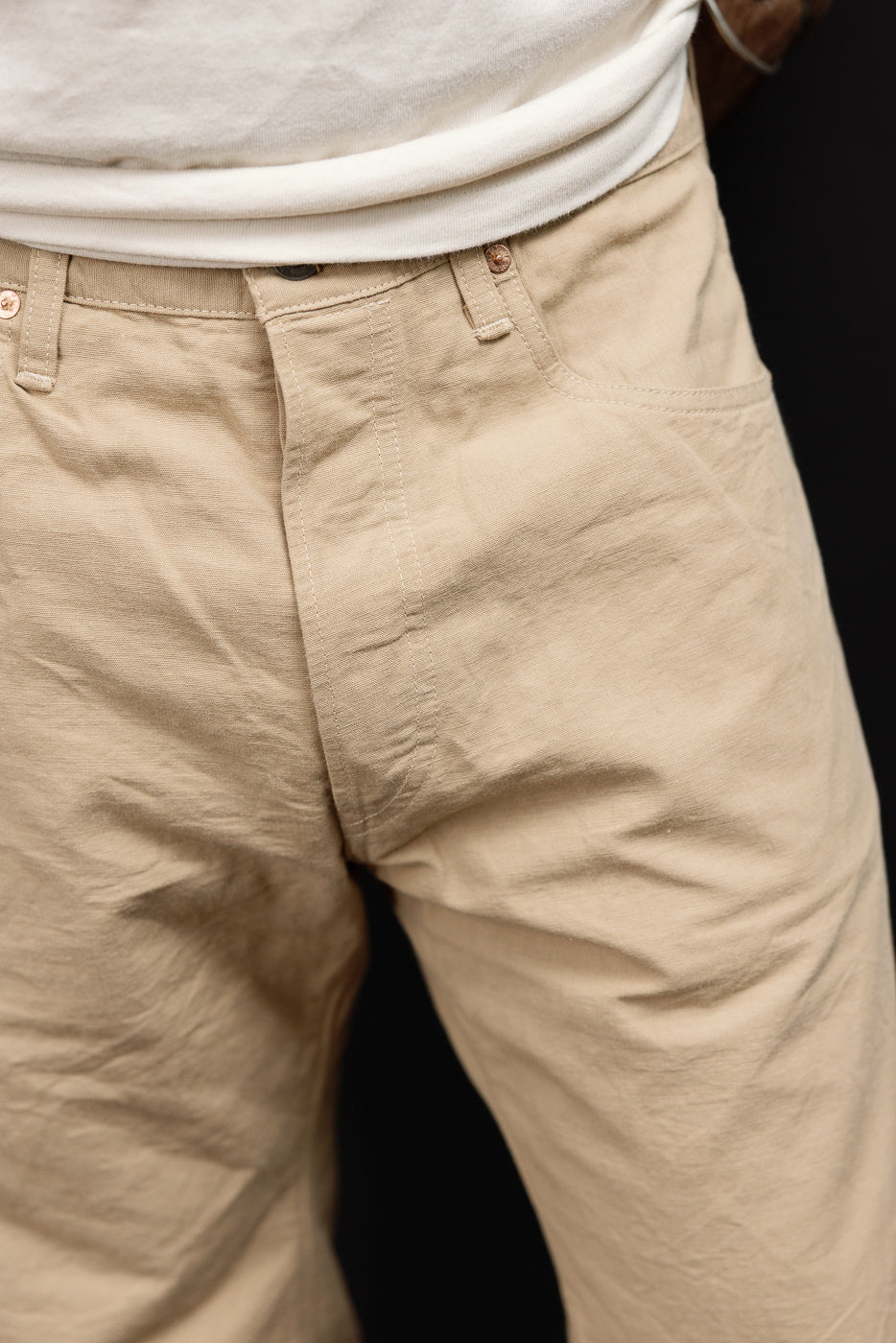 Close-up front view of beige casual pants on male model, 5'9