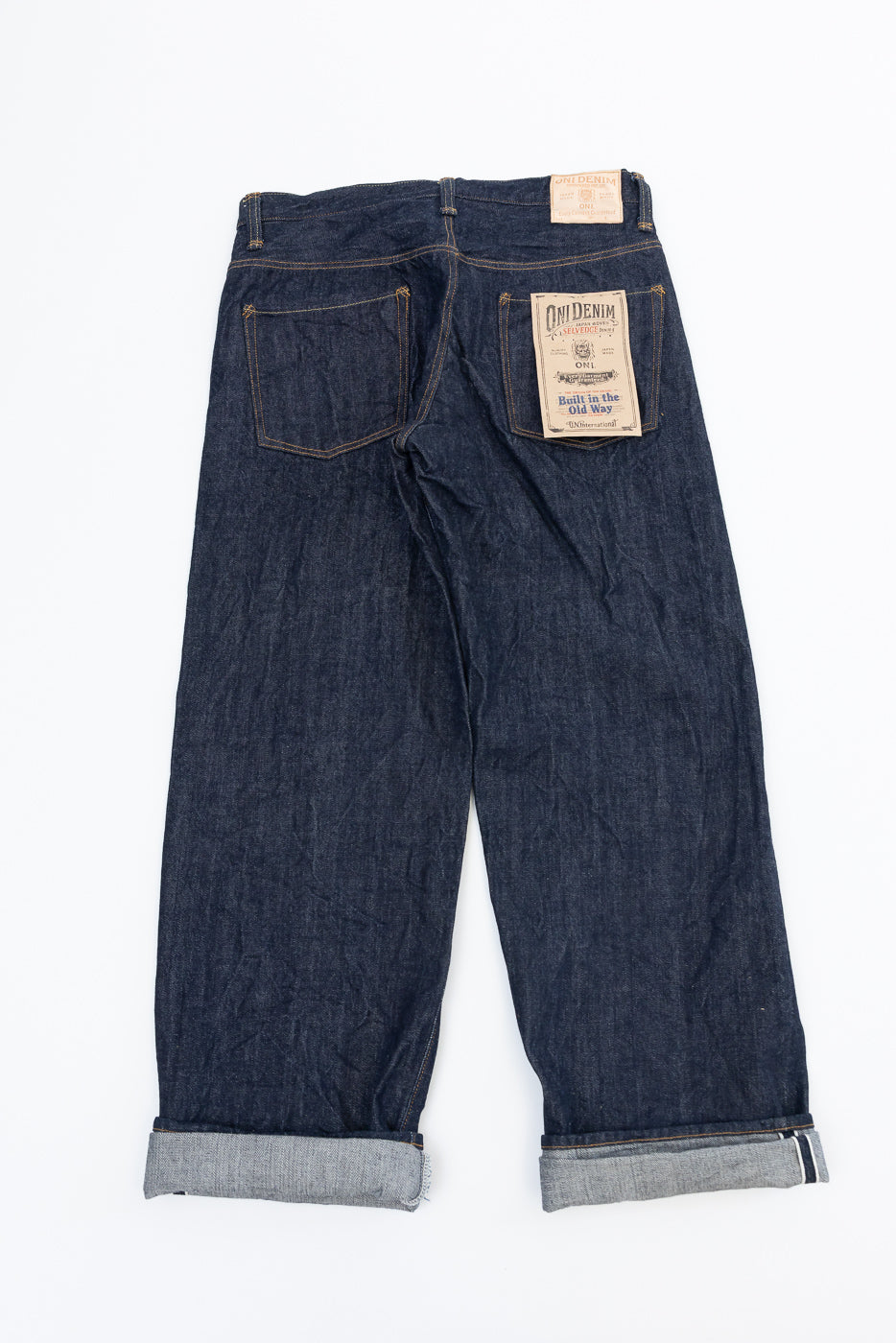 Back view flat lay of Oni Denim selvedge jeans showing back pockets and brand patch.