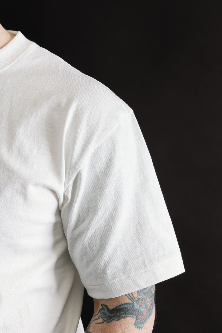 Close-up of white short sleeve t-shirt right side, worn by 5'9 male model, athletic build
