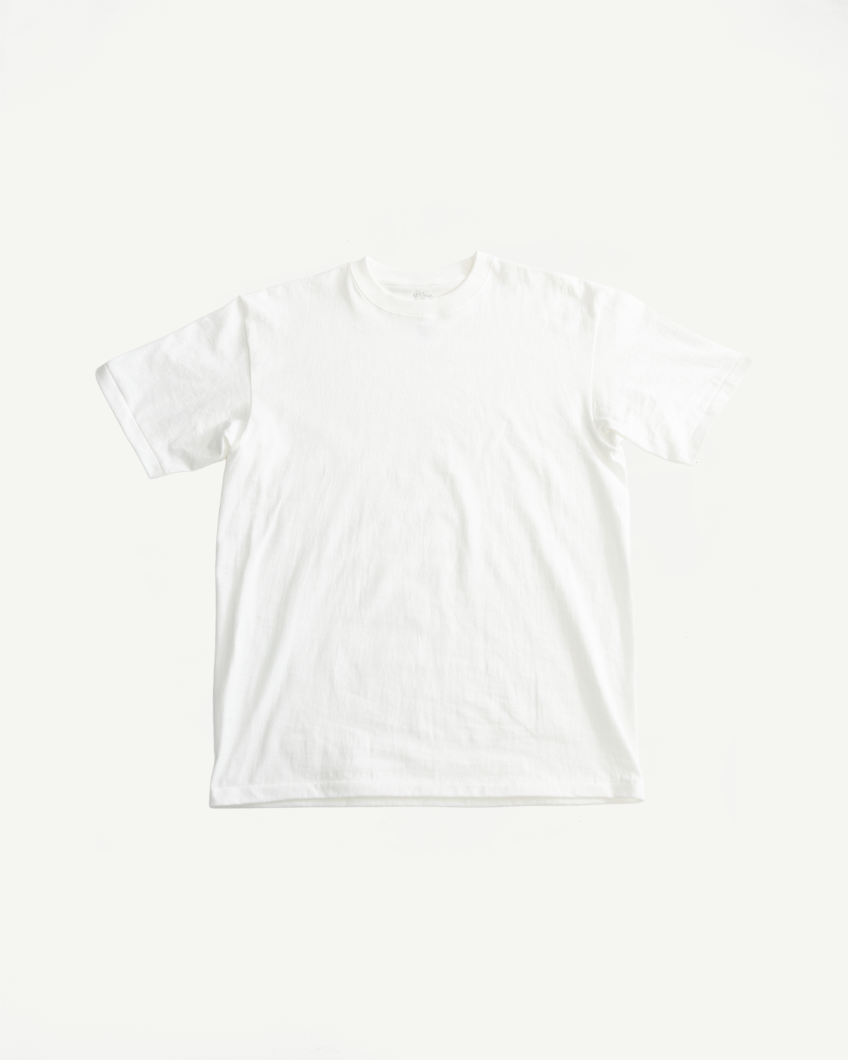 Flat lay of white short sleeve t-shirt, front view, showing classic crew neck and straight hem.