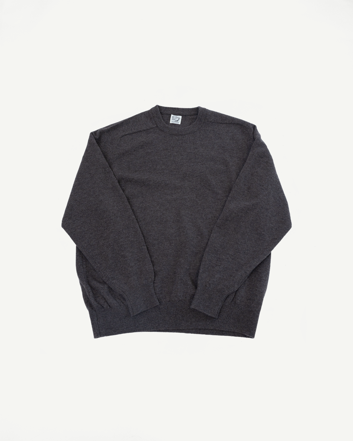 Flat lay front view of a charcoal grey crewneck sweater with ribbed cuffs and hem.