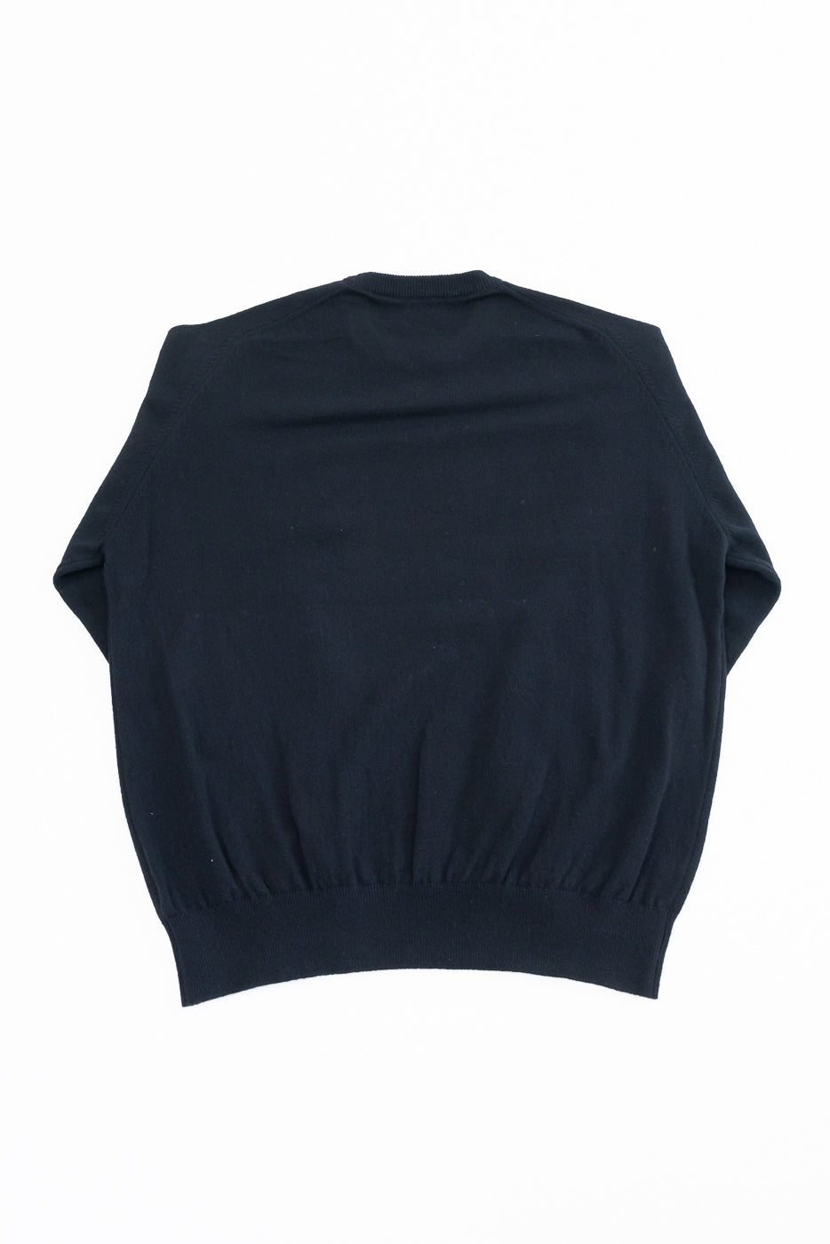 Back view of a navy blue crewneck sweater flat lay.