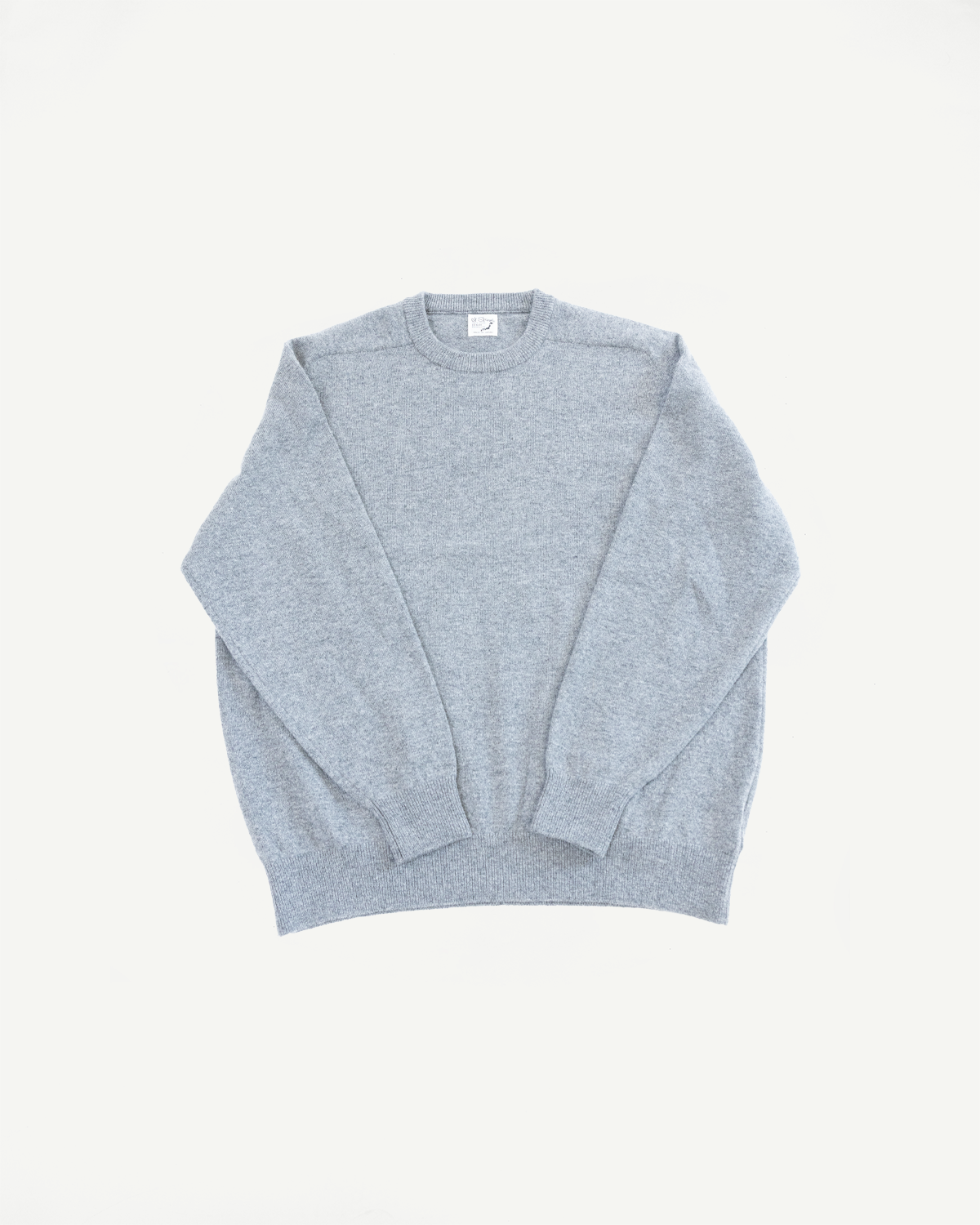 Front view flat lay of a light gray crewneck sweater with ribbed cuffs and hem.