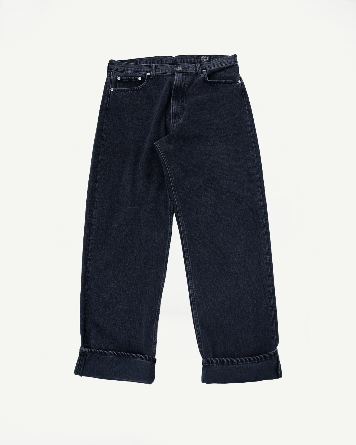Front view flat lay of dark wash wide-leg denim jeans with cuffed hems.