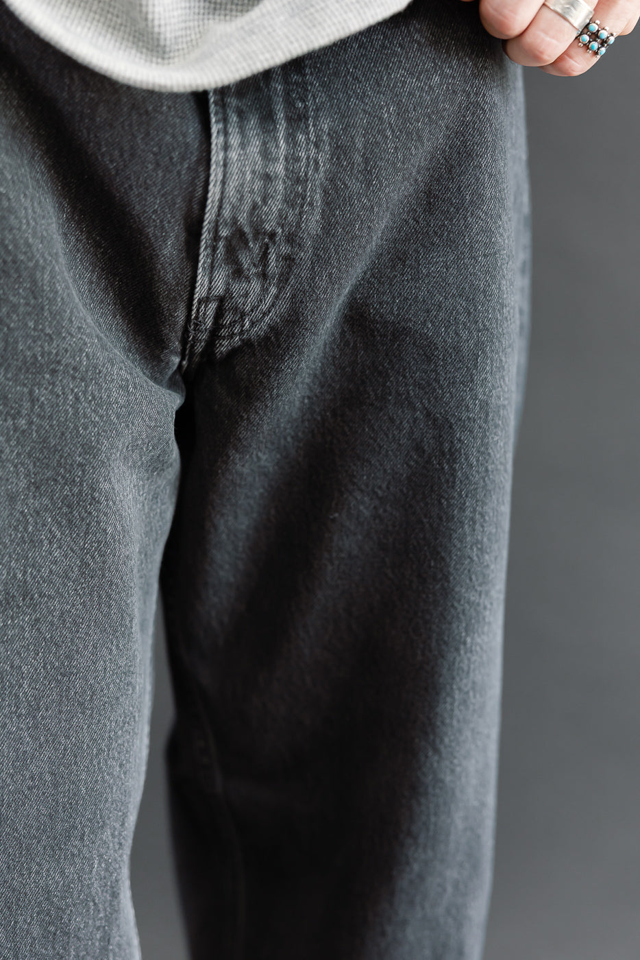Close-up front view of grey denim jeans texture on a 5'9