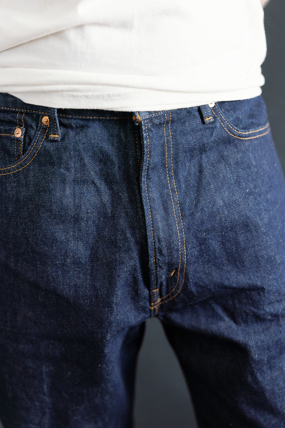 Close-up of men's Orslow Dad's Fit Denim, front waist detail, on 5'9