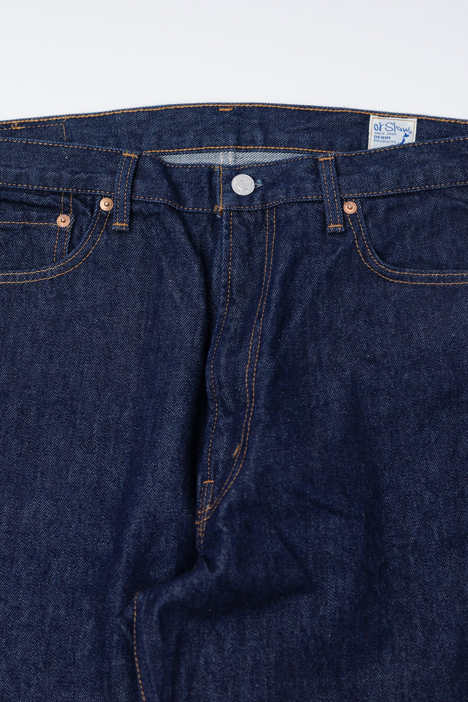 Close-up front view of orSlow Dad’s Fit denim jeans, showing button, rivets, and fabric texture.