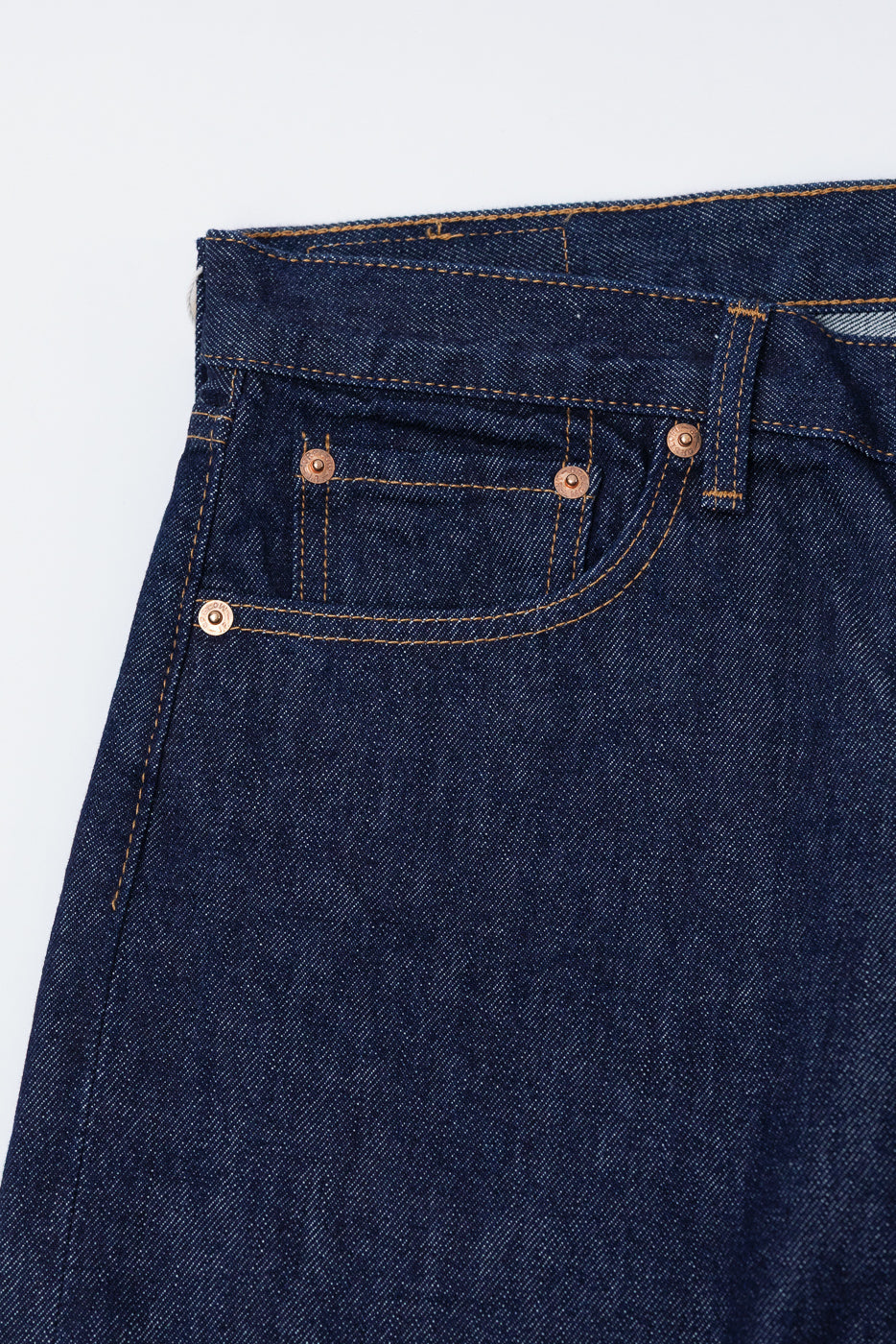 Close-up of orSlow Dad's Fit denim jeans front left pocket, selvedge indigo fabric, rivet details
